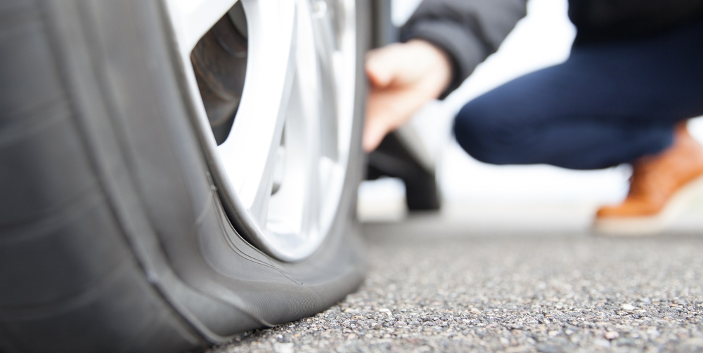 person checking flat tyre