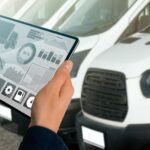 person holding iPad looking at fleet